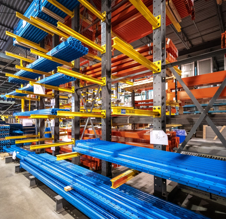 Palettier cantilever industriel pour le stockage de charges longues, avec bras porteurs jaunes et structures métalliques en entrepôt
