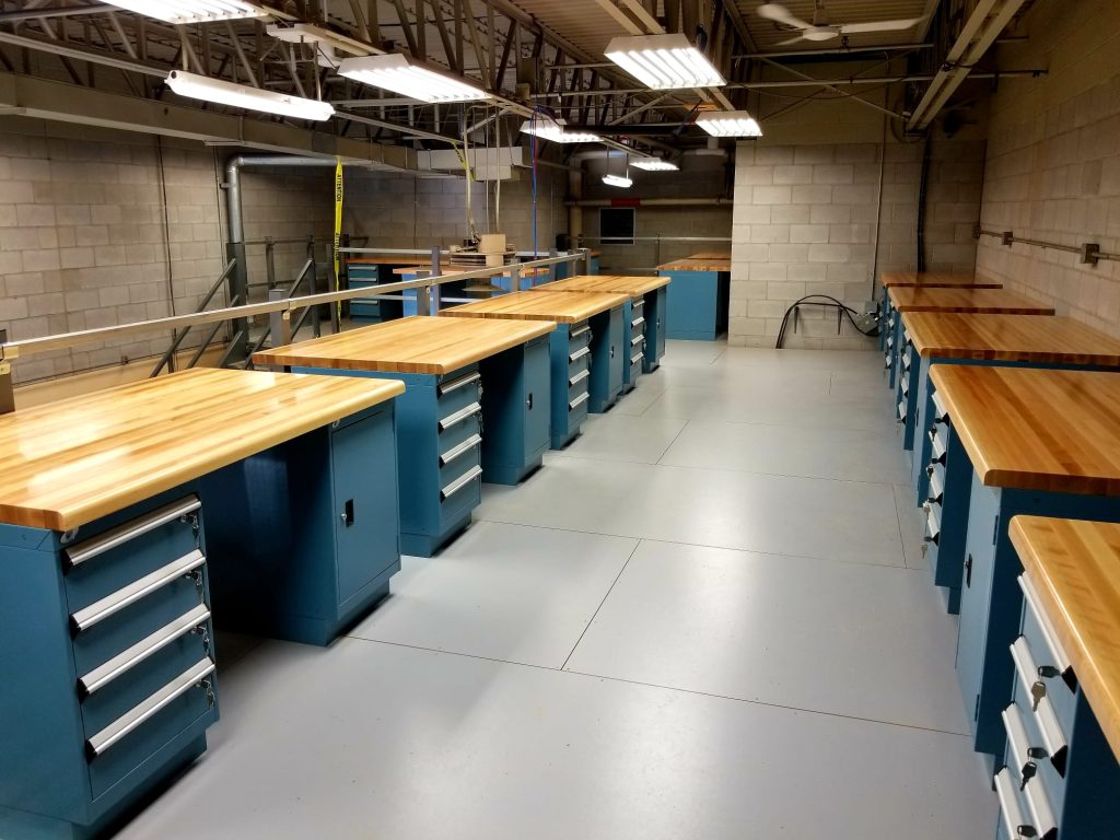 Industrial workstations with wooden desktops and integrated storage drawers, ideal for office desks and workshop environments.