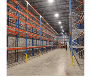Empty warehouse racking structure during installation phase in a modern epoxy-finished facility