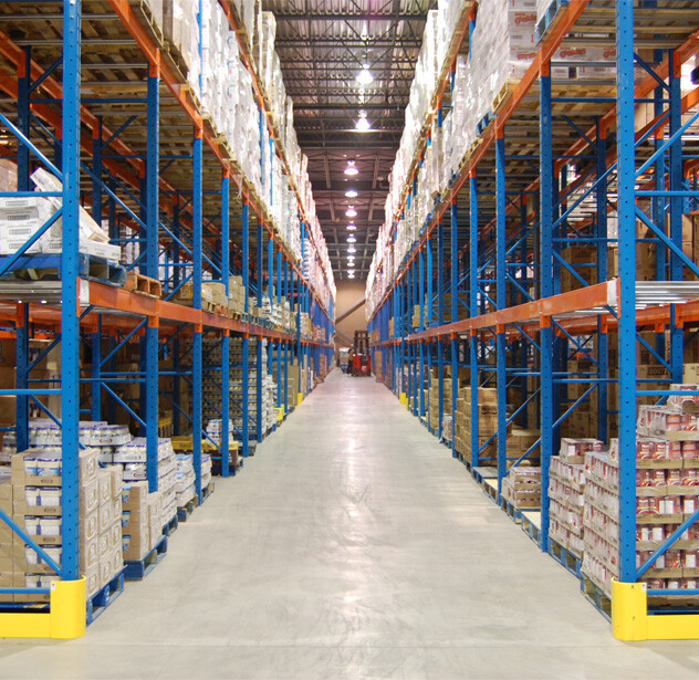 High-capacity warehouse racking system with tall pallet racks fully stocked along wide aisles