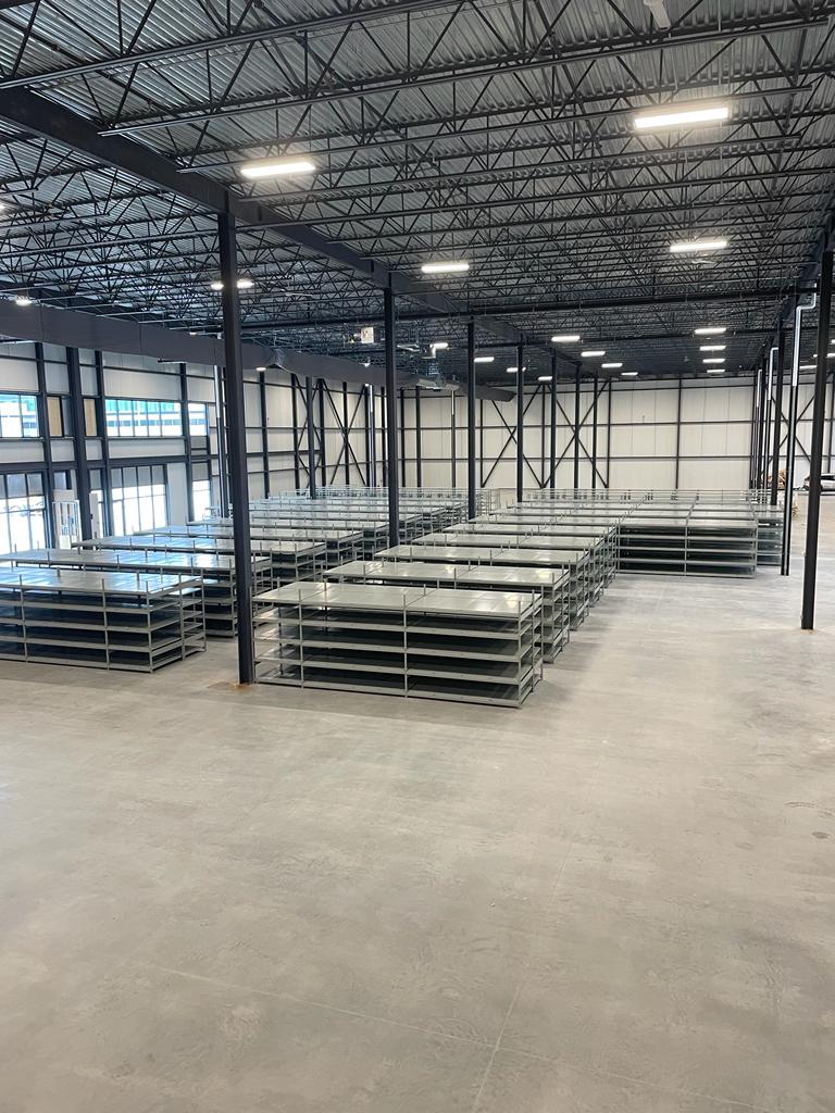 pallet rack installation in warehouse with industrial storage system setup in progress