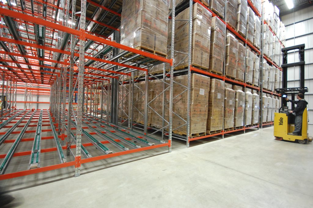 pallet rack installation in warehouse with high density storage system and forklift operations
